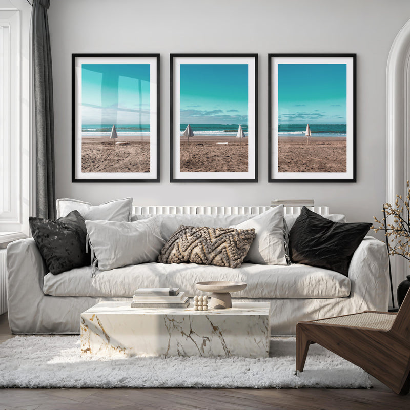 Closed Umbrellas beach pictures for wall beside Blue Surf - Black Framed Poster with White Border - Artworksets
