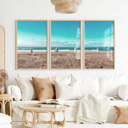Closed Umbrellas beach pictures for wall beside Blue Surf - Natural Wood Framed Poster No Border - Artworksets