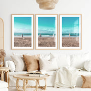 Closed Umbrellas beach pictures for wall beside Blue Surf- Natural Wood Framed Poster with White Border - Artworksets