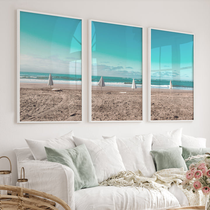 Closed Umbrellas beach pictures for wall beside Blue Surf - White Framed Poster No Border - Artworksets