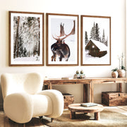 Winter Wall Art – Snowy Forest, Deer & Wooden Cabin - Dark Brown Framed Poster with White Border - Artworksets